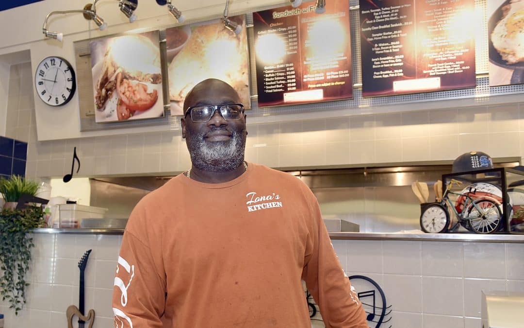 Restaurant owner distributing hot free meals to those in need